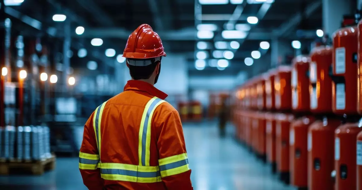 Fire safety officer inspecting industrial facility emergency response equipment — Ignis Sentinel Engineering