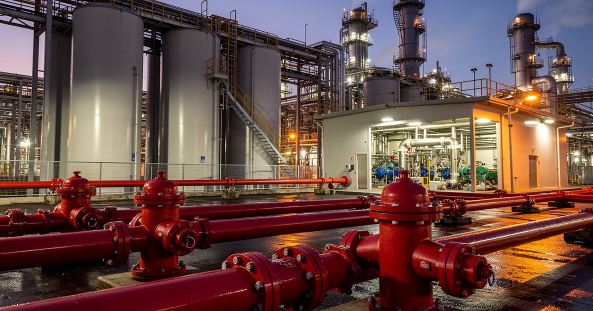 Industrial fire water supply system with hydrants, underground mains, and pump house at a petrochemical refinery